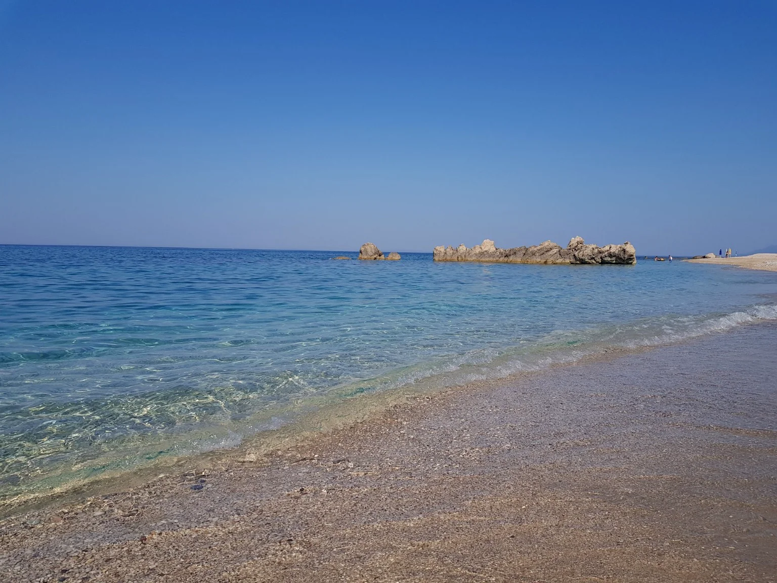Crystal-clear shallow Ionian Sea water at the beach near Villa Vanda