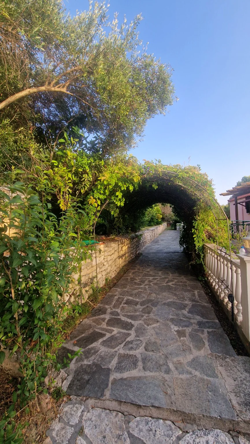Stone garden walkway surrounded by Mediterranean greenery at Villa Vanda