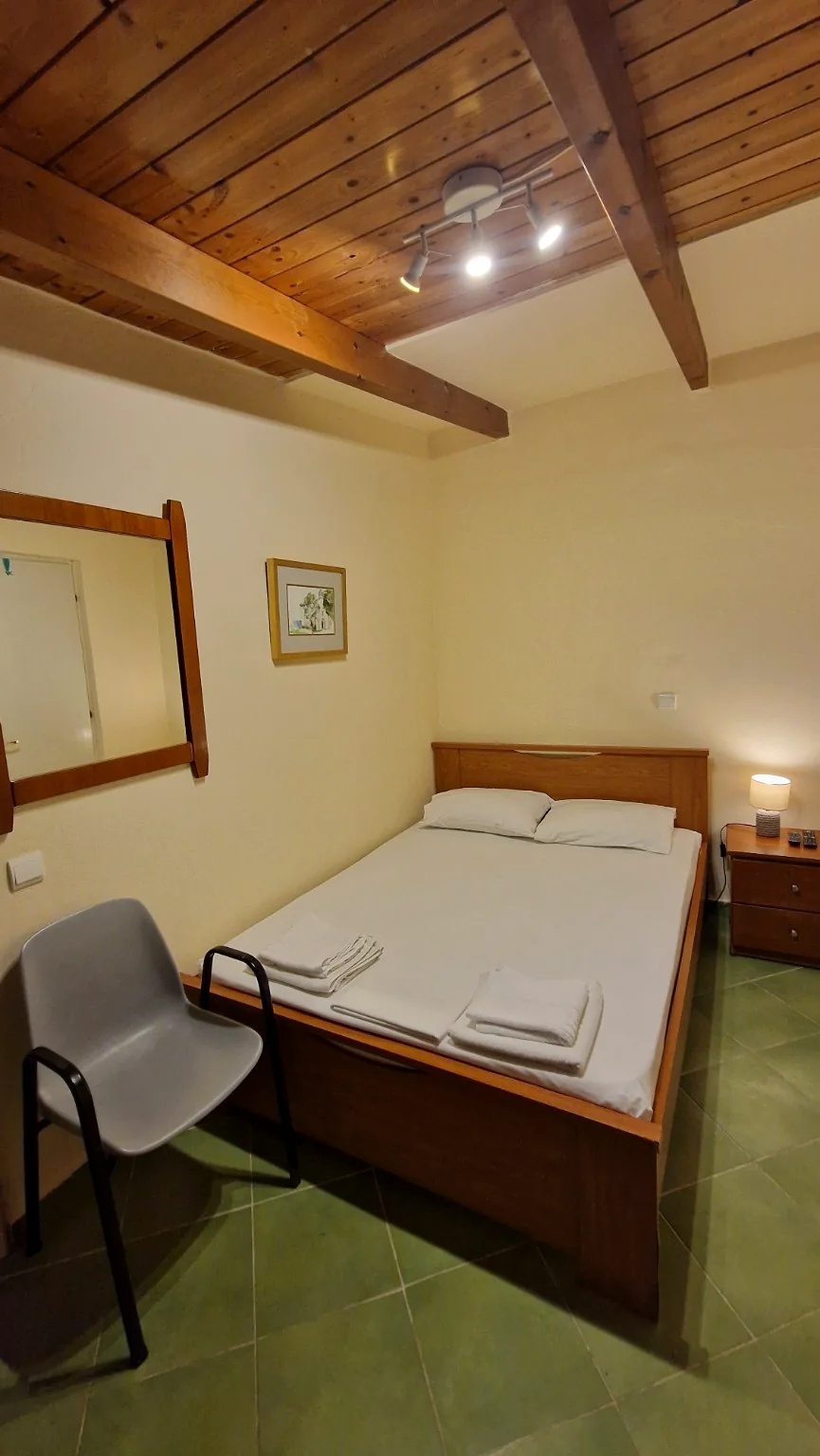 Second double bedroom with wooden ceiling at Il Prato, Villa Vanda