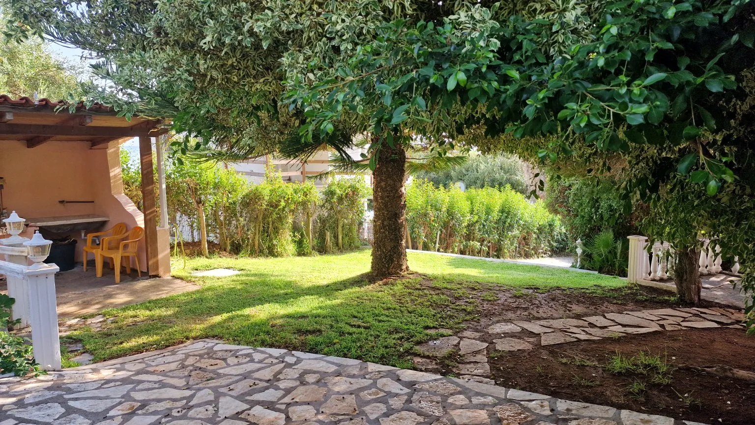 Garden lawn and trees outside Il Prato at Villa Vanda