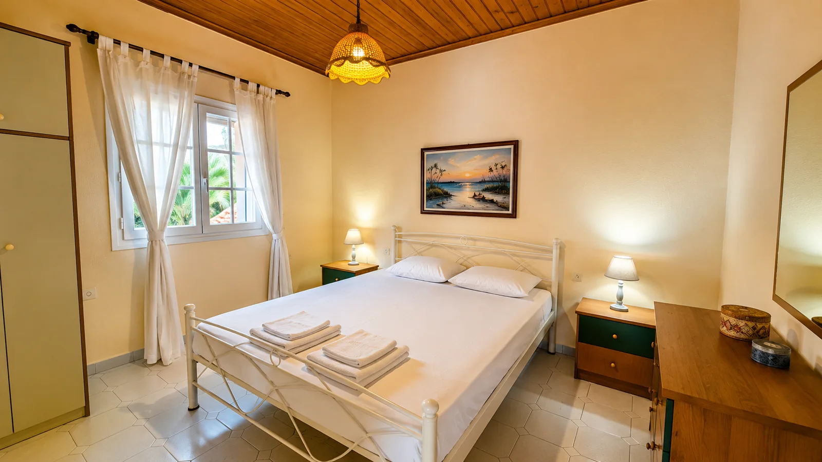 Double bedroom with white linens and wooden ceiling at La Terrazza, Villa Vanda