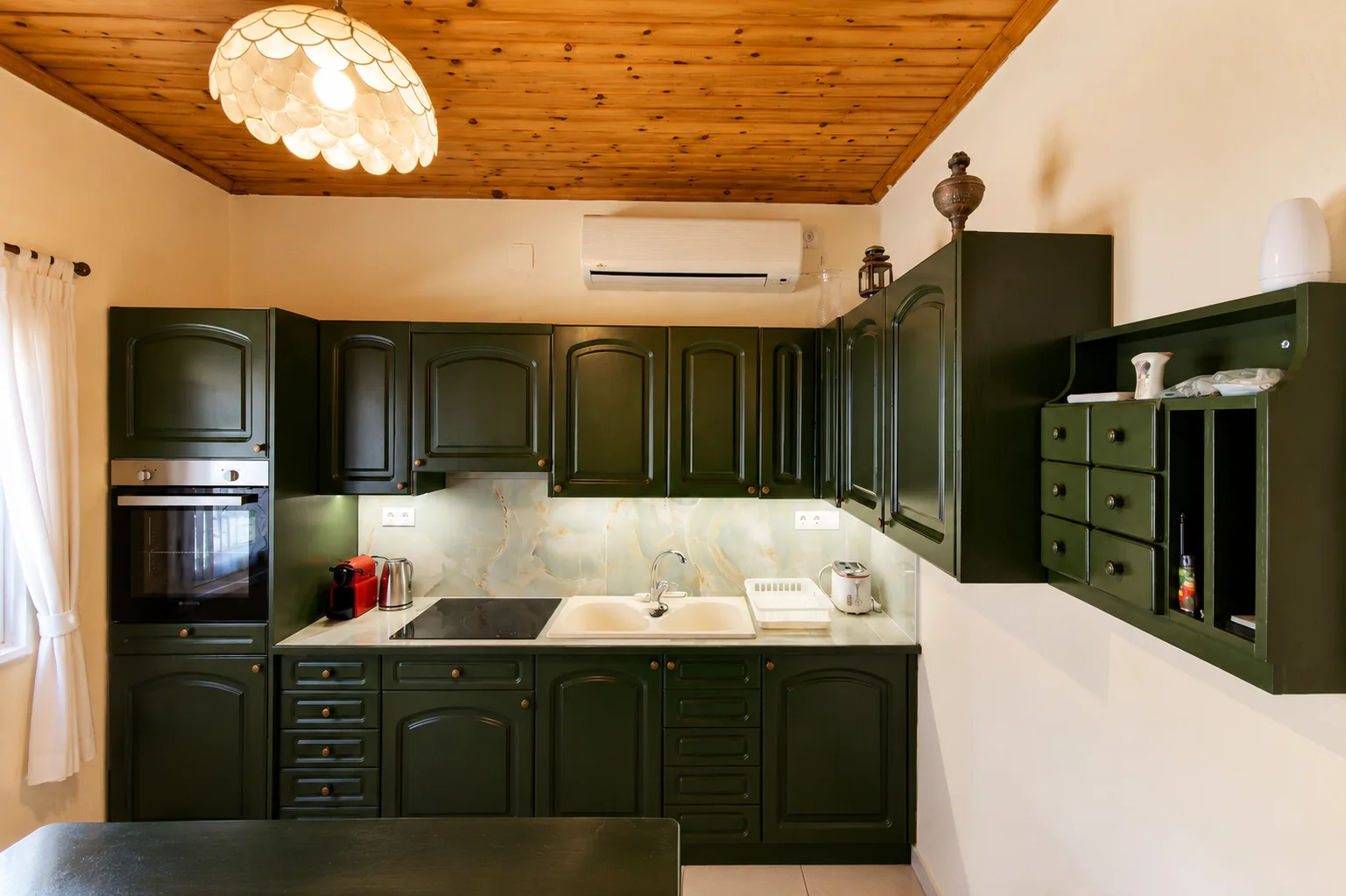 Fully equipped kitchen with green cabinetry at La Terrazza, Villa Vanda