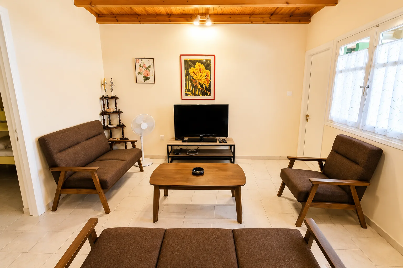 Comfortable living room with TV and wooden ceiling at La Terrazza in Lygia, Preveza