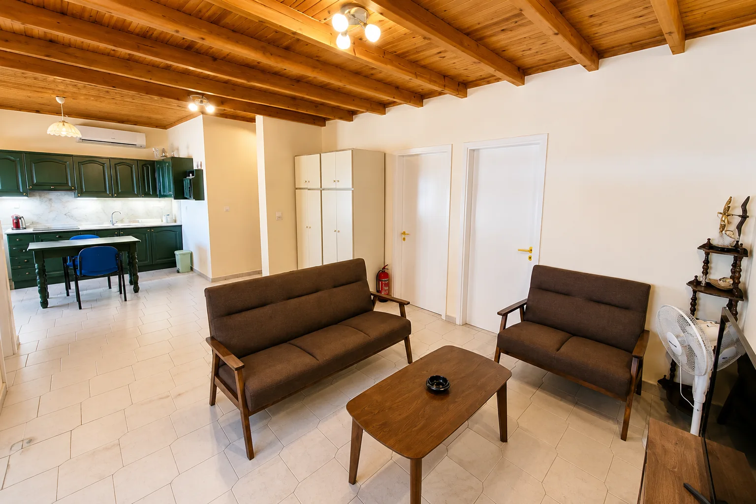 Open-plan living room and kitchen with wooden ceiling at La Terrazza, Villa Vanda