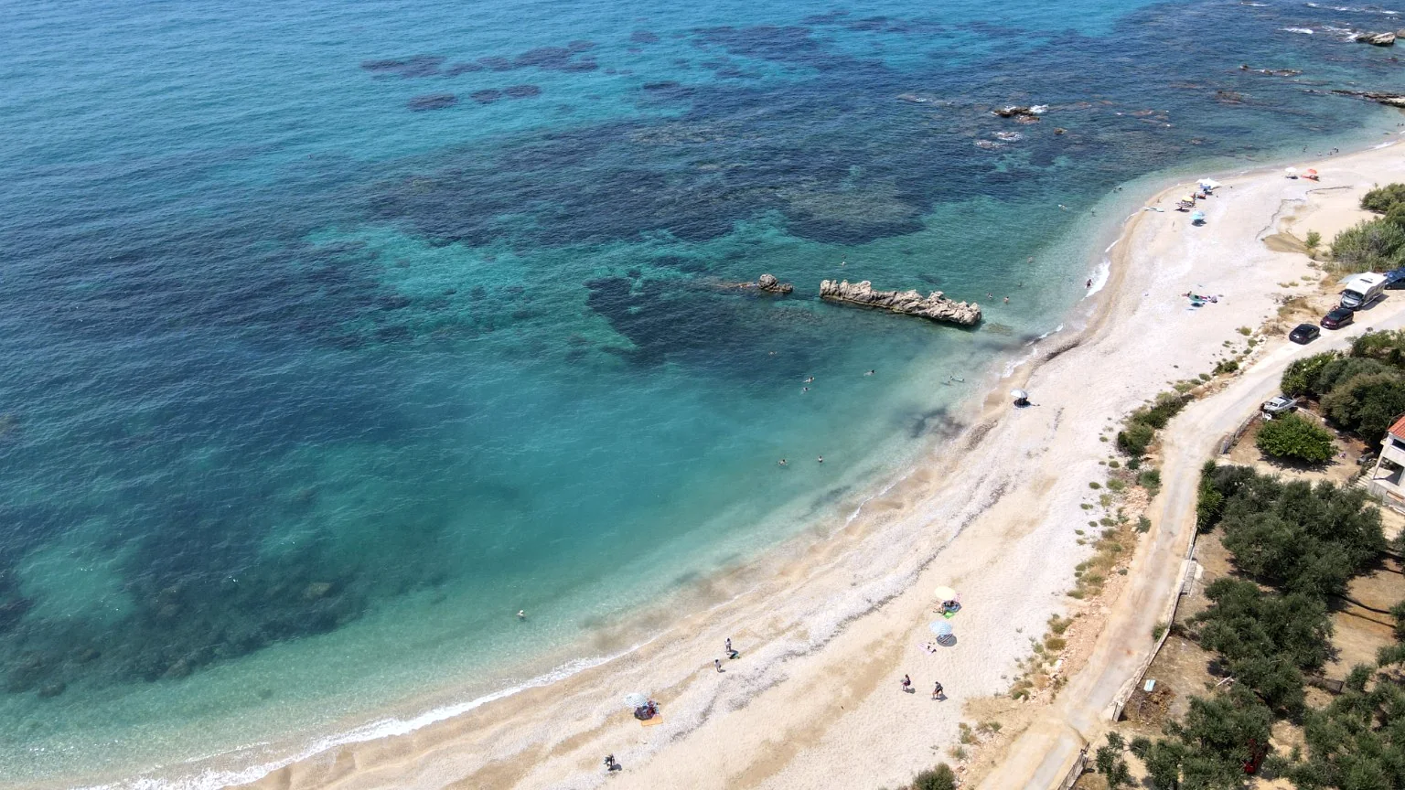 Aerial view of the clear turquoise water and beach near Villa Vanda in Lygia, Preveza