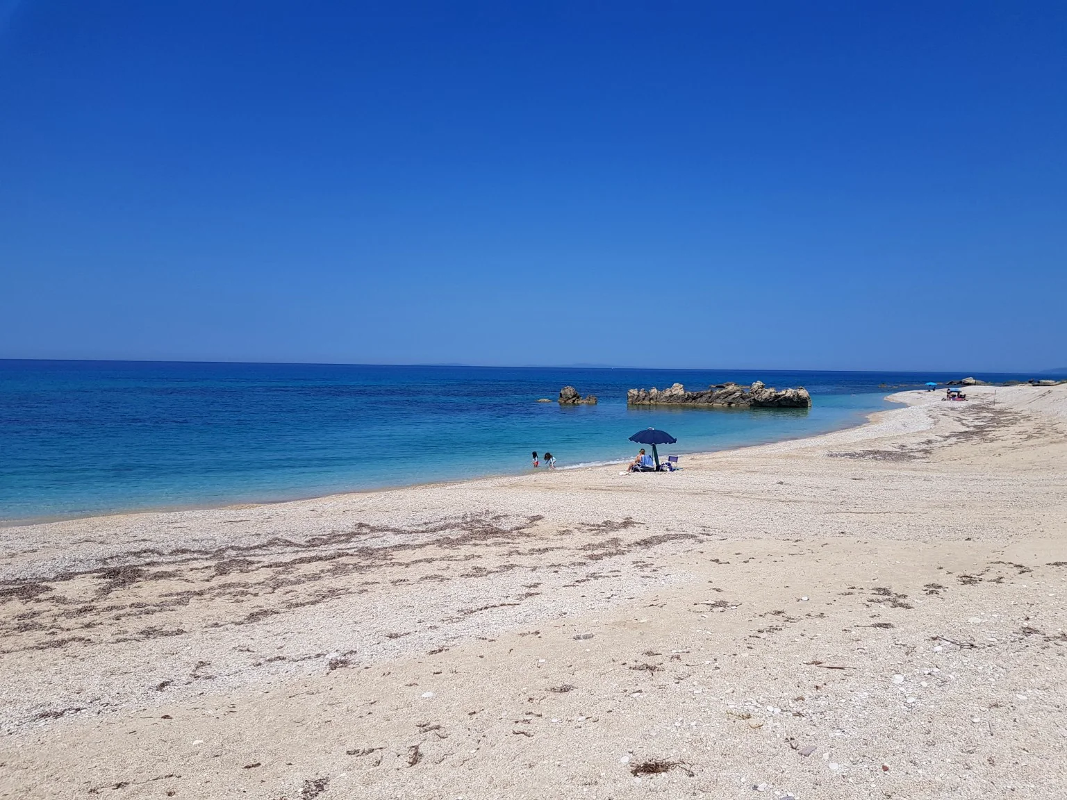 Wide view of the quiet beach and blue Ionian Sea near Villa Vanda in Lygia
